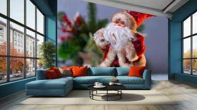 a toy figure of Santa Claus on skis goes on holiday Wall mural