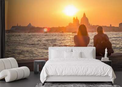 Two girls admire the scenic sunset over Santa Maria della Salute in Venice Wall mural