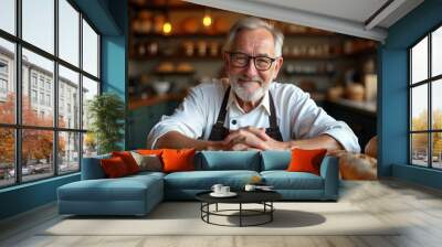 In a bakery, an elderly male baker smiles warmly, hands on sourdough bread. Warm light and depth highlight the textures, with a blurred background for text.












 Wall mural