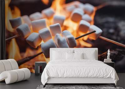 marshmallows toasting on a stick over a campfire Wall mural