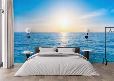 Blue ocean with sun reflection, sun shining on sky background Wall mural