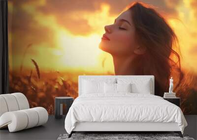 Freedom and healthy concept - beautiful young girl against sunset. Wall mural