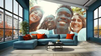 Multi ethnic guys and girls taking selfie outdoors with backlight - happy life style friendship concept on young multicultural people having fun day together in barcelona - bright vivid filter. Wall mural