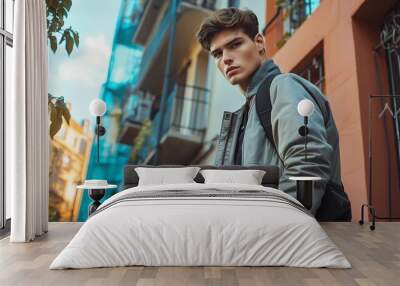 Photo of a young fashion stylish trendy look man model in color clothes modern style outdoor street style natural light. Wall mural