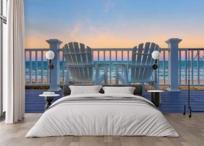 Adirondack Chair sits on the balcony deck of a house looking out over the beach and the ocean Wall mural