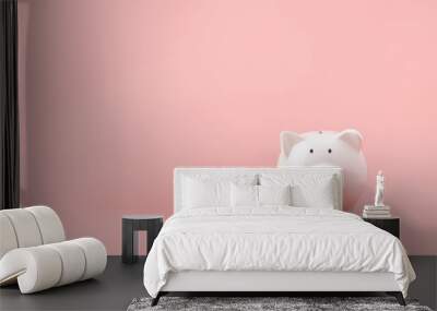 Money saving and investment concept. Piggy bank and coin stack on pink background with copy space Wall mural