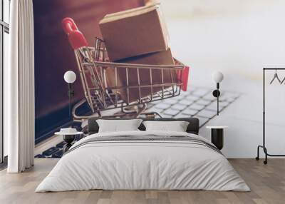 Shopping online. cardboard box in a trolley on laptop keyboard. Shopping service on The online web. offers home delivery Wall mural