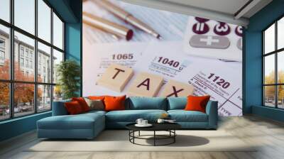 Tax season with wooden alphabet blocks, calculator, pen on 1040 tax form backgrounda Wall mural