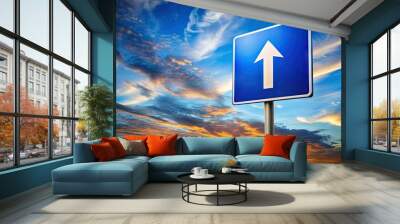 A illuminated highway symbol sign at dusk, with a bold white arrow pointing forward, against a vibrant blue sky with wispy clouds. Wall mural