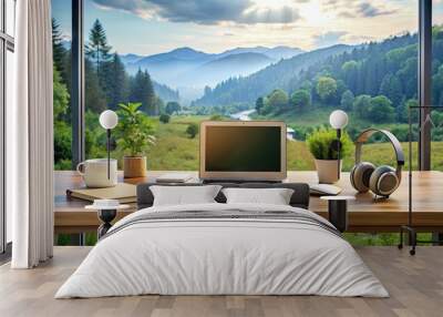 A modern home office setup with laptop, notebooks, and headphones on a desk, surrounded by calm natural scenery, exemplifying a peaceful remote work environment. Wall mural