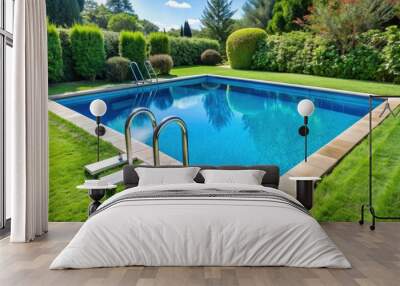 Serene swimming pool with crystal-clear blue water and elegant Grecian-style border, featuring a metal ladder and surrounded by lush green grass. Wall mural