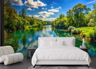 two tranquil rivers merge, their crystal-clear waters blending seamlessly, surrounded by lush greenery and towering trees under a bright blue sky. Wall mural