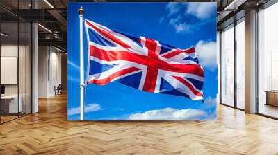 Vibrant red, white, and blue Union Jack flag waves proudly in the breeze, symbolizing national pride and heritage Wall mural