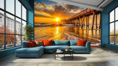 Warm sunrise casts a golden glow on the iconic fishing pier, waves gently lapping at its weathered wooden pilings, against a serene coastal Virginia Beach backdrop. Wall mural