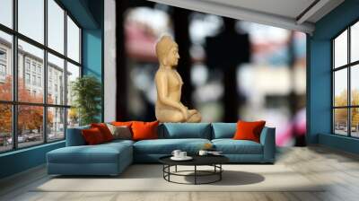 Beside of beige color resin of buddha statue. A carved Buddha figurine. Wall mural