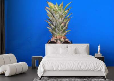 Pineapple wearing sunglasses. Wall mural