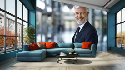 portrait of successful senior businessman consultant looking at camera and smiling inside modern office building Wall mural