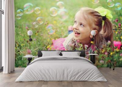 happy little girl playing with bubbles Wall mural