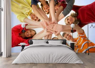 A group of happy teenagers holding hands together Wall mural