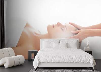 An attractive woman getting spa treatment on a white background Wall mural