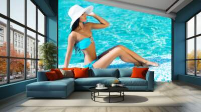 Beautiful and sporty girl relaxing in a pool at summer Wall mural