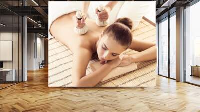 Close-up of young woman in spa. Traditional healing therapy and massaging treatments. Wall mural