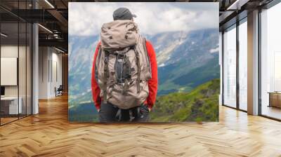 Hiker traveling in Alps. Alpine peaks landskape background. Jungfrau, Bernese highland. Sport, tourism and hiking concept. Wall mural