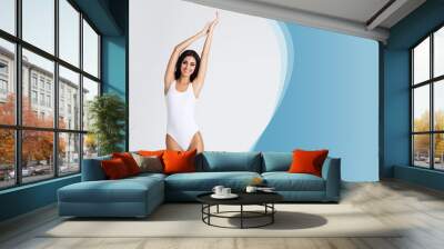 Slender healthy girl posing in white bodysuit - copyspace template. Fit and sexy woman in underwear swimsuit. Slim body shape, nutrition, sport, fitness and diet. Wall mural