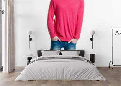 Teenage boy in a pink shirt and jeans isolated on white Wall mural