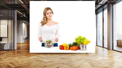 young and beautiful housewife woman cooking in a kitchen Wall mural