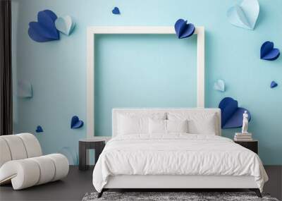 A creative flat lay with paper hearts and an empty frame arranged on a soft blue backdrop, ideal for a variety of design and craft projects Wall mural