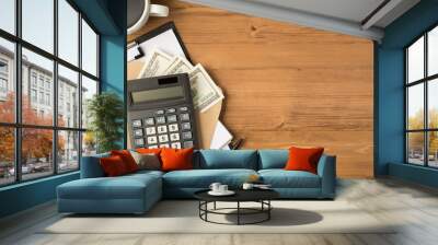 Above photo of calculator notebook clipboard two pens envelope with money dollars and cup of coffee isolated on wooden backdrop Wall mural