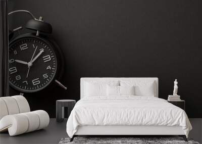 Black friday shopping concept. Top view photo of black alarm clock on isolated black background with copyspace Wall mural