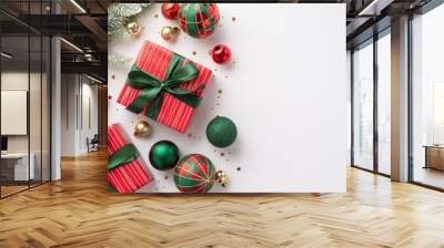 Christmas concept. Top view photo of red green and gold baubles star ornament gift boxes with ribbon bows pine branch in snow and shiny confetti on isolated white background with copyspace Wall mural