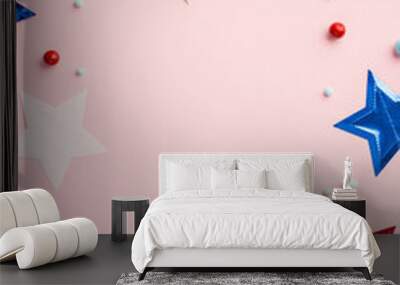 Fourth of July concept. Top view vertical photo of US national flags stars and scattered candies on isolated pastel pink background with empty space in the middle Wall mural