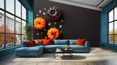 Halloween decorations concept. Top view photo of pumpkins centipedes spiders and ghost silhouettes confetti on isolated black background with copyspace Wall mural