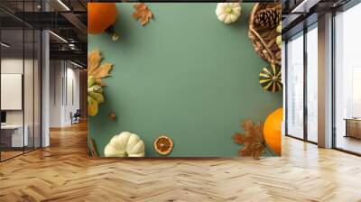 Immerse yourself in the beauty of the fall harvest season. Top-down image featuring mature pumpkins and classic autumnal elements on a green isolated background, suitable for messages or promotions Wall mural