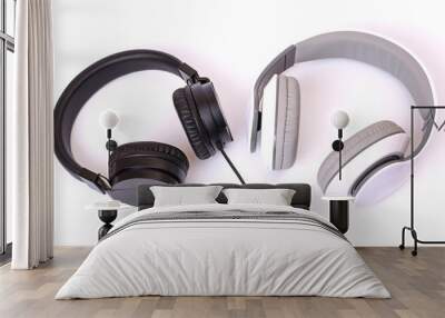 Opposite contrast contrary vs comfortable stylish style concept. Top overhead above close up view photo of a pair of dark and light headphones with cables isolated on background copy-space Wall mural