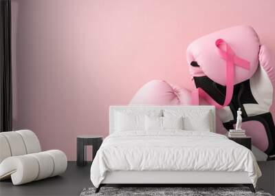 Pink boxing gloves with a pink ribbon highlight breast cancer awareness and strength against cancer Wall mural