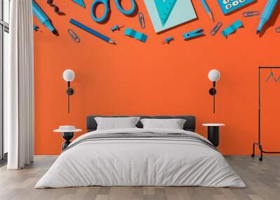 Top view photo of blue school accessories stationery markers pencils scissors pins clips sticky note paper ruler and calculator on isolated orange background with copyspace Wall mural