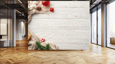 Winter holidays concept. Top view photo of red christmas decorations pine branches craft paper giftbox knitted scarf and anise on white wooden table background with copyspace Wall mural