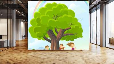 Children playing around a tree with rainbow, landscape, and mountains in the background.  Wall mural