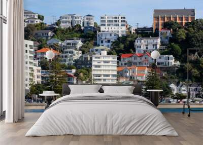 Popular inner city summer spot Oriental Parade beach with residential house, apartments and church, and people enjoying the sun in capital Wellington, New Zealand Aotearoa  Wall mural