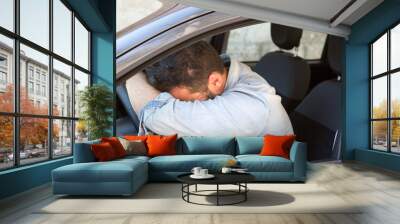 Man sleeping in a car Wall mural