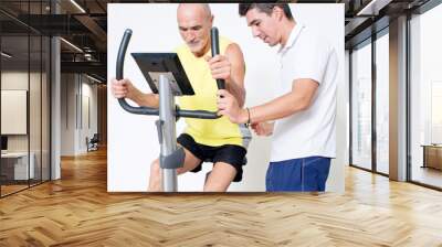 Personal trainer correcting spinning exercise Wall mural