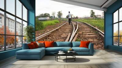 Lugazi, Uganda. 17 May 2017. A railway track in rural Uganda. A man walking along it. Wall mural