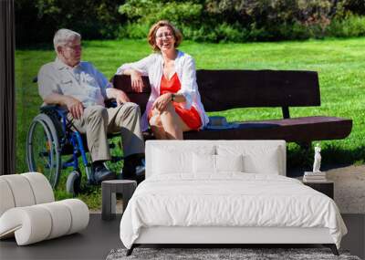 old man on wheelchair and young woman on a bench Wall mural