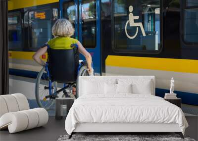 woman sitting on wheelchair on a platform Wall mural