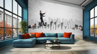 Business concept of risk support and assistance with man balancing on rope Wall mural