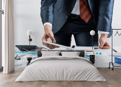 Businessman standing near office desk Wall mural